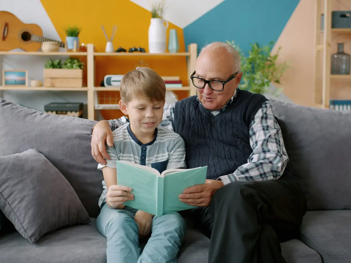 Avô e neto lendo um livro juntos